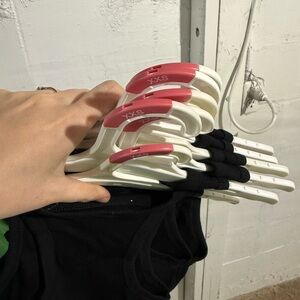 Set of Black Tank Tops on White Hangers with Pink Size Tabs